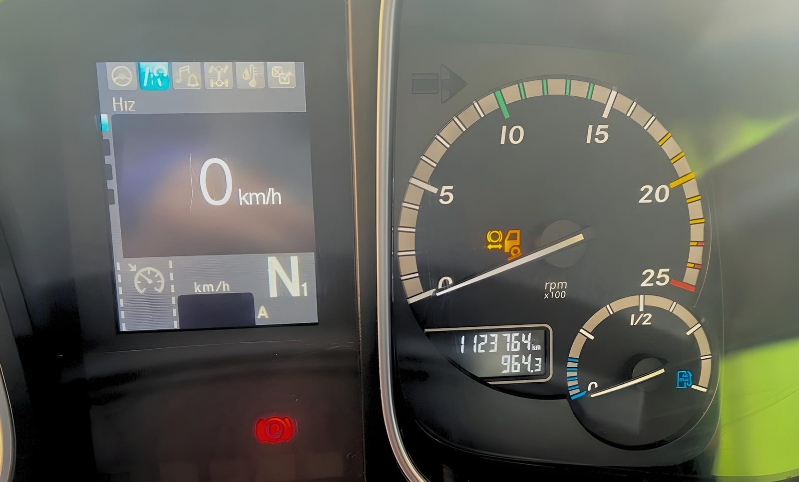Mercedes-Benz Actros instrument cluster with the odometer reading 1,123,764 km, equal to roughly 700,000 miles