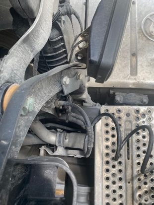 Close view of the coiled cable and connector at the chassis connection point after eight years of service
