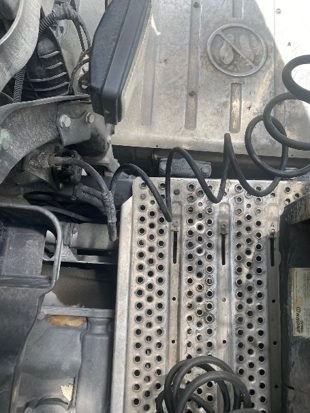 Coiled cables and air lines on the tractor deck plate behind the cab
